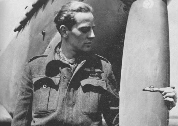 Jack proudly holds his fathers RAF wings againts a propeller blade of his Spitfire.  He carried those wings with him throughout the war 