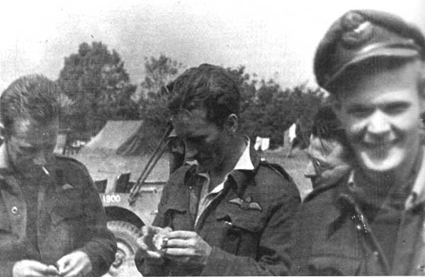 Jamieson (left) & Wilf Banks examining some flak just after they shot down a 109 & Jack Sheppard 